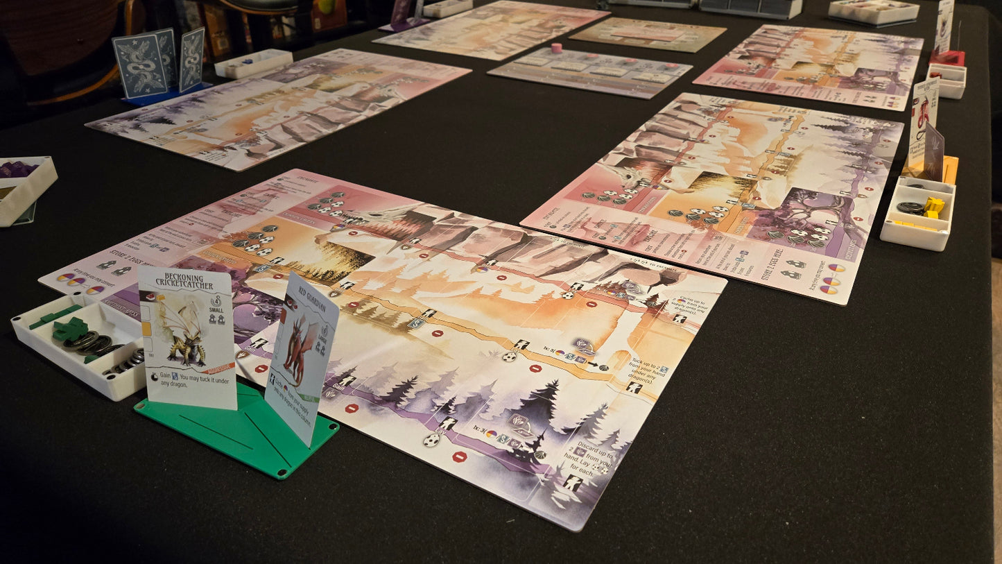 Board game pieces and cards on a dark surface