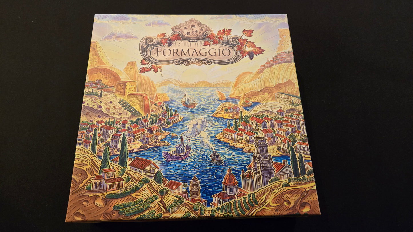 Board game box titled 'Formaggio' with a scenic illustration on a dark background