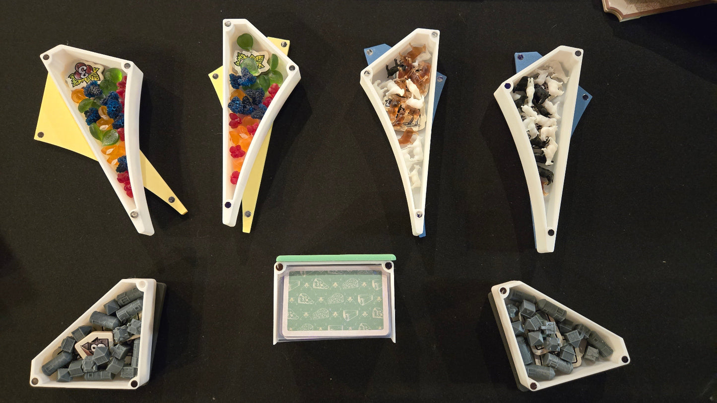 Set of triangular containers with various contents on a dark surface