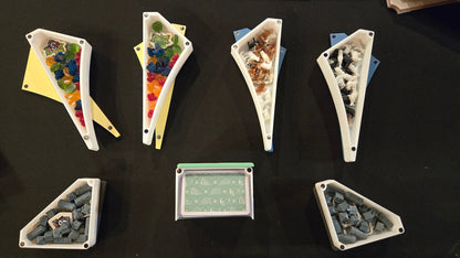 Set of triangular containers with various contents on a dark surface
