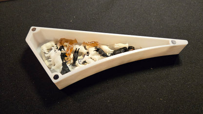 White ceramic dish with decorative stones on a black background