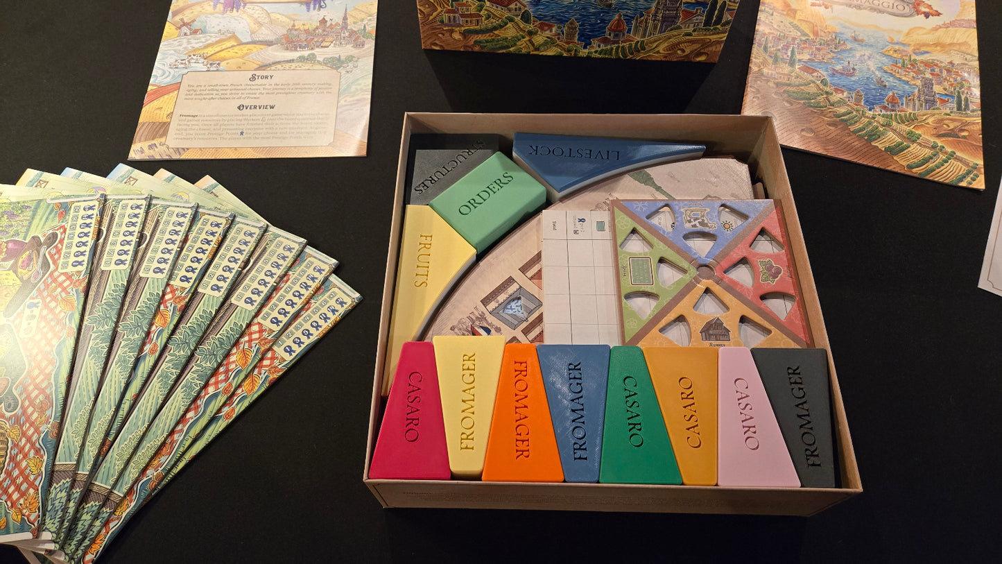 Board game components including cards and pieces on a dark surface