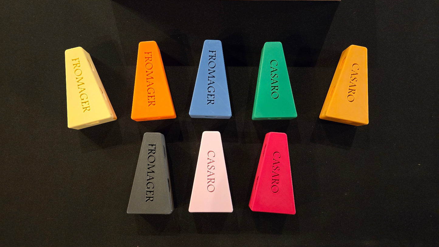 Set of colorful cheese-shaped chalks with brand names on a black background