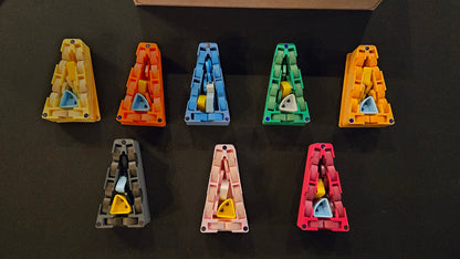 Nine colorful letter 'A' shaped objects on a black background