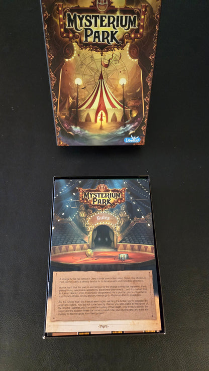 Two 'Mysterium Park' board game boxes on a black background