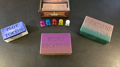Game components including plot tokens, people locations cards, and vision cards on a dark surface.