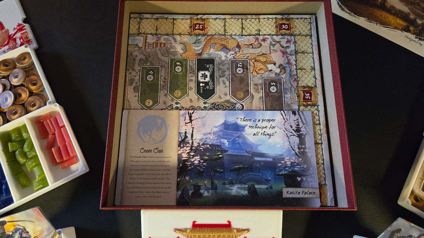 Board game box with detailed artwork on a dark surface