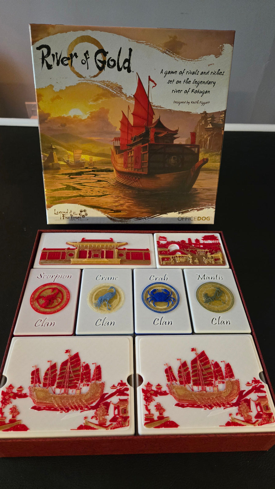 Board game box titled 'River of Gold' with illustrations on a dark background