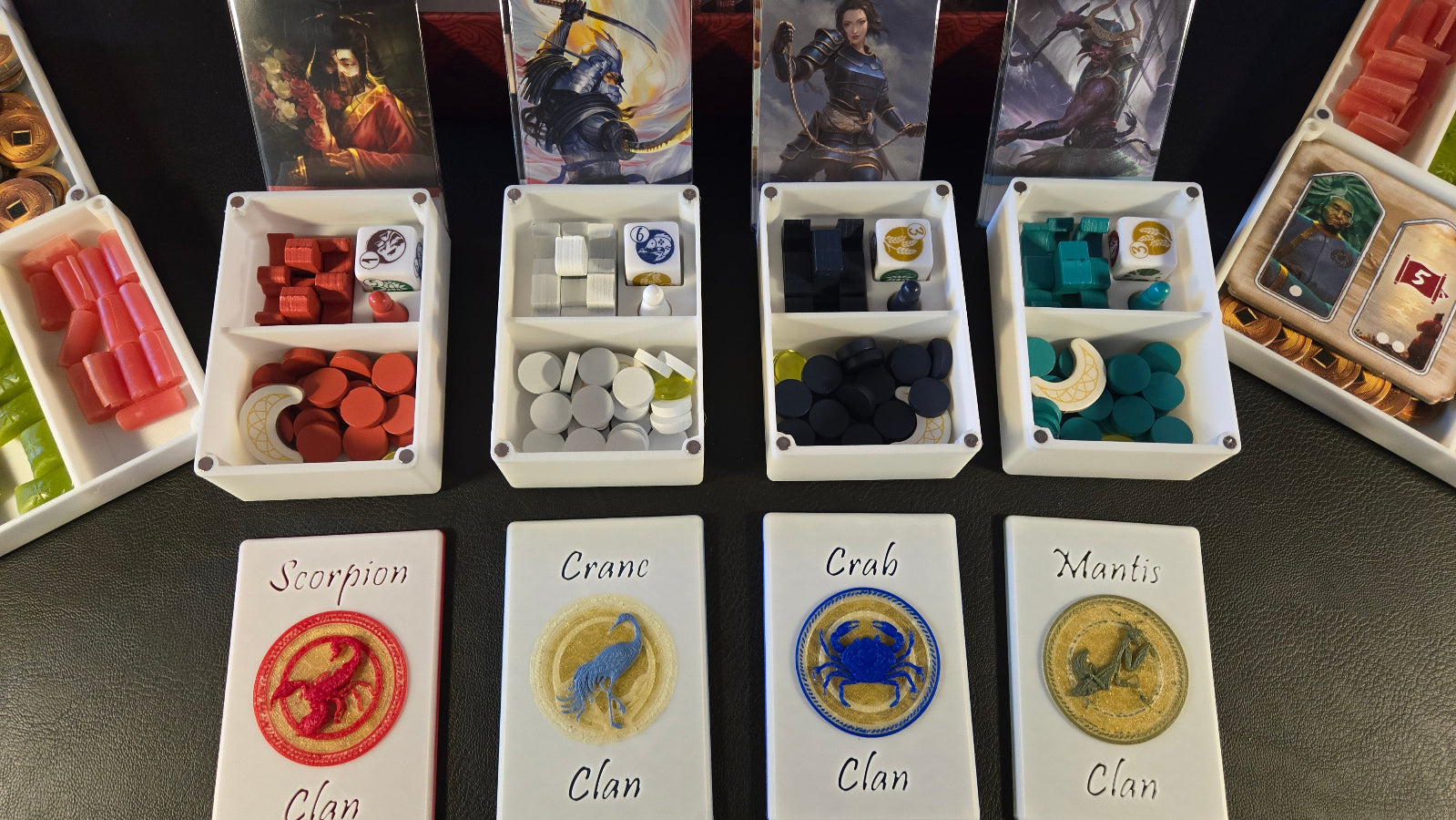 Board game components including cards and dice on a dark surface