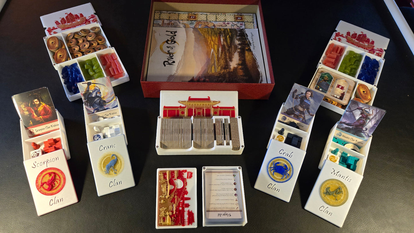 Collection of board game components including cards and boxes on a dark surface