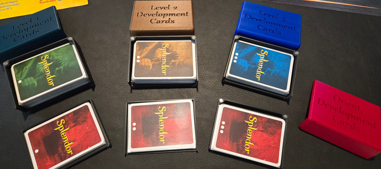 Collection of 'Splendor' game cards and boxes on a dark surface