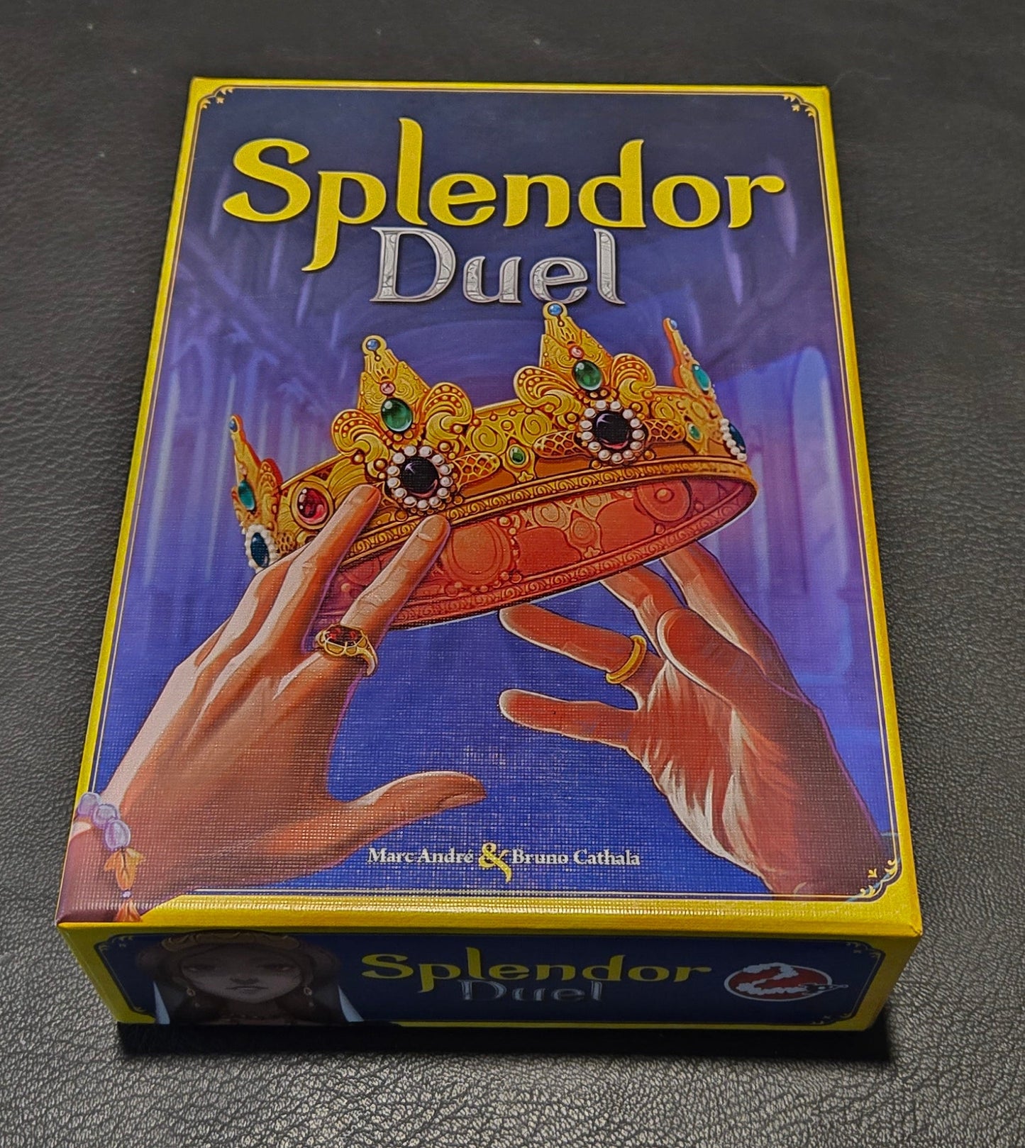 Box of 'Splendor Duel' game on a dark textured surface