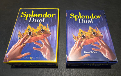 'Splendor Duel' game box with hands holding crowns on a dark background