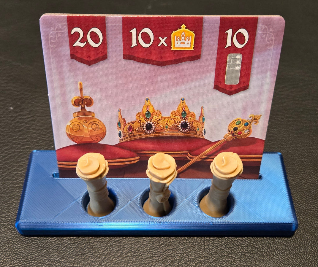Small card with gold designs and text on a blue stand against a dark background
