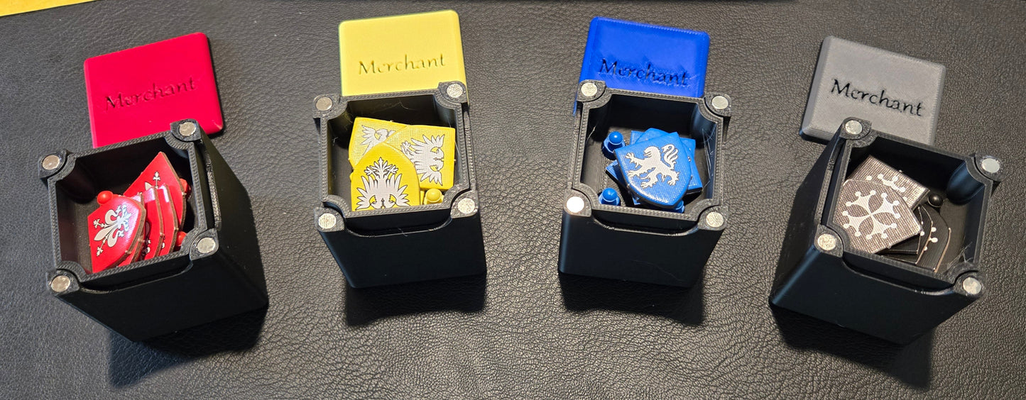 Five small black boxes with colorful labels on a gray surface