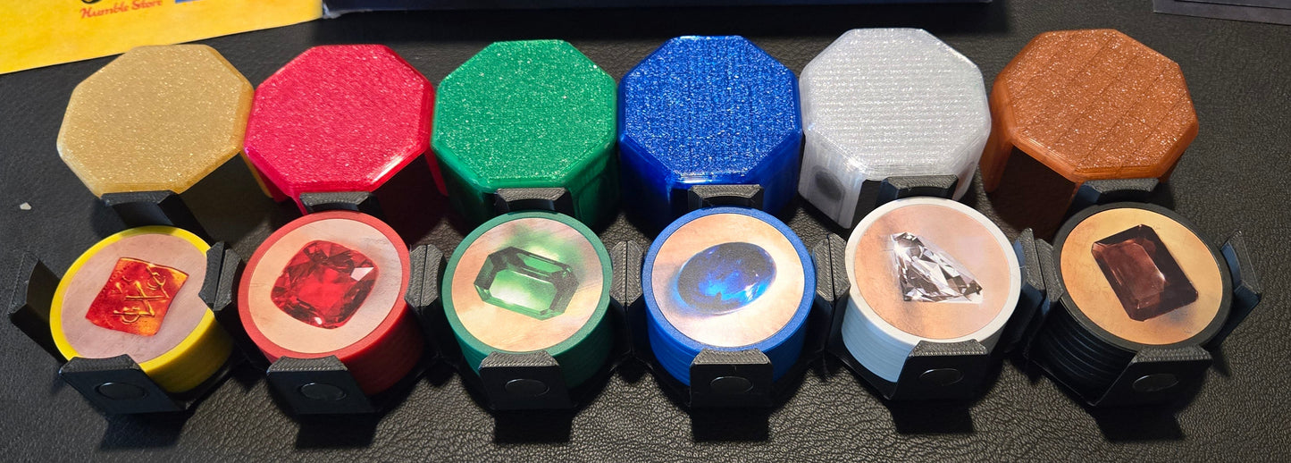 Collection of colorful game pieces with 'Splendor' box in the background