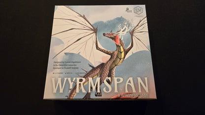 Board game box for 'Wyrmspan' with a dragon illustration on a dark background