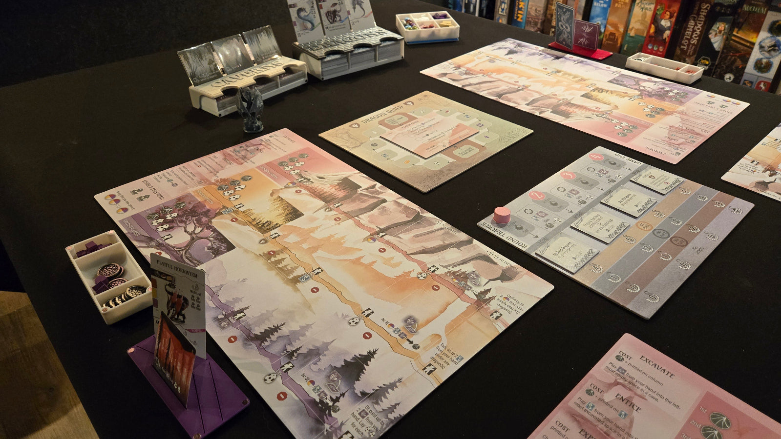 Board game setup on a table with various game pieces and boards.