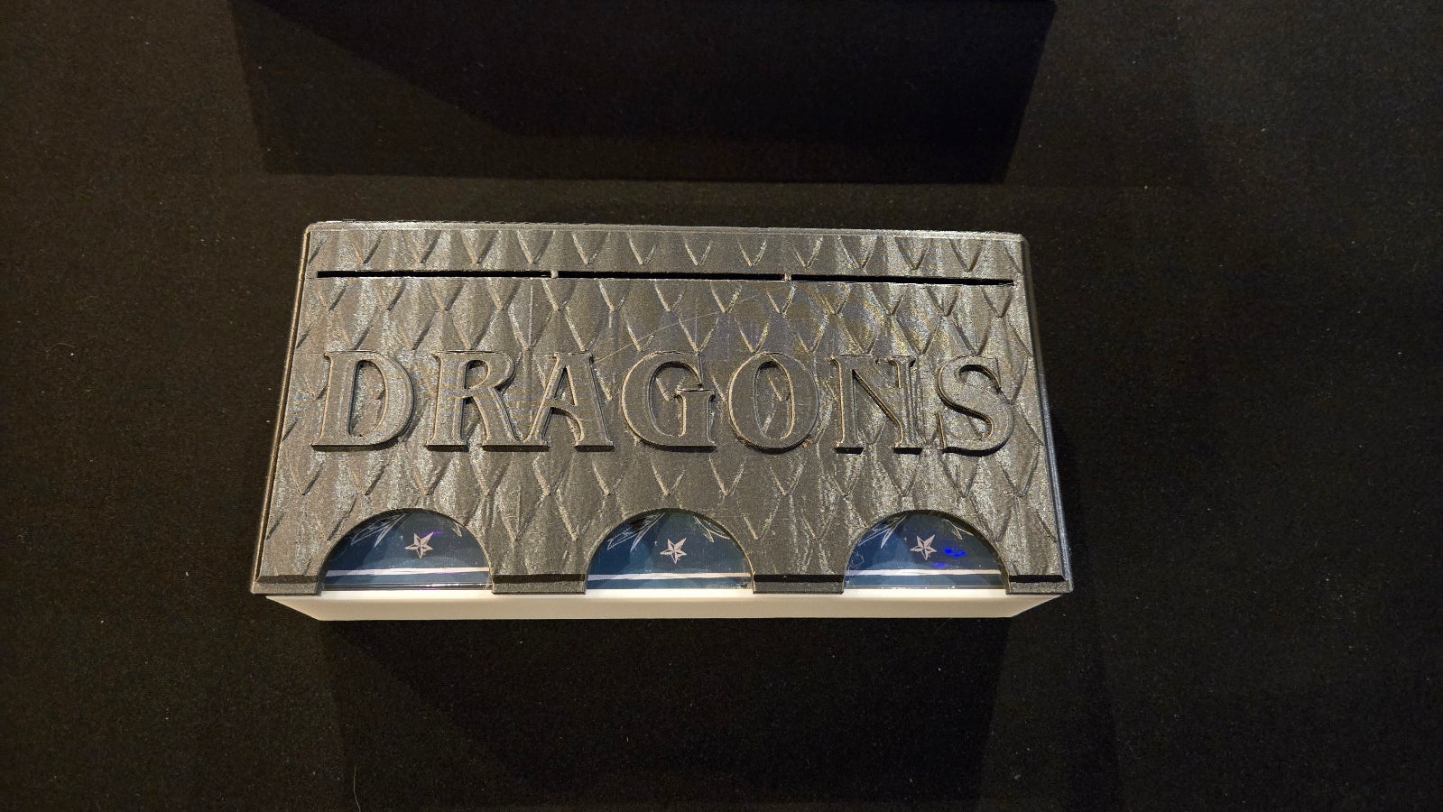 Cardboard box with 'My Dragons' branding on a black background