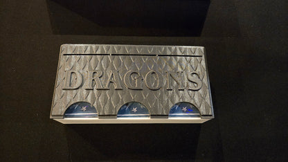 Cardboard box with 'My Dragons' branding on a black background