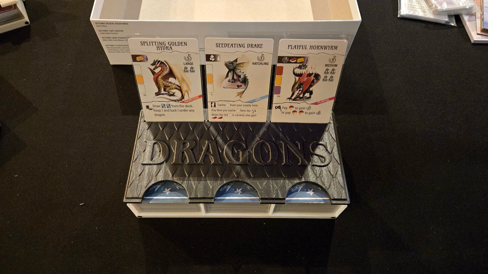Card display with 'Dragons' branding on a dark surface