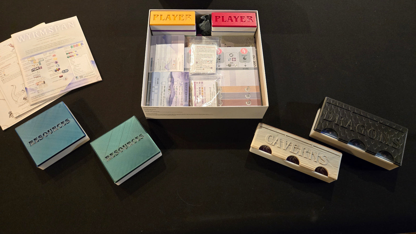 Collection of vintage playing cards and card holders on a dark surface