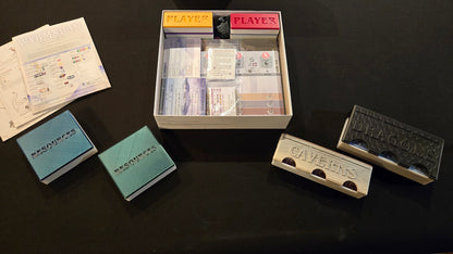 Collection of vintage playing cards and card holders on a dark surface