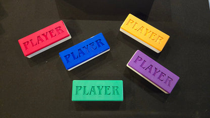 Five rectangular 'PLAYER' markers in different colors on a black background
